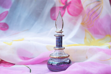 Glass perfume bottle in pink and purple shades