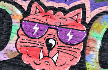 Colorful background of graffiti painting artwork with bright aerosol outlines on wall. Old school...