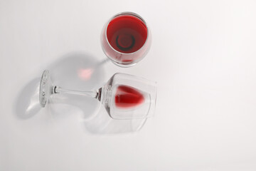Tasty red wine in glasses isolated on white, top view
