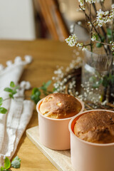 Easter traditional bread on rustic wooden table with flowers. Fresh baked homemade easter cake in forms. Orthodox traditional food paska