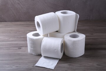 Soft toilet paper rolls on wooden table