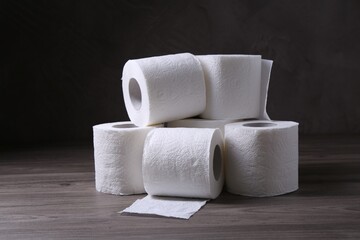 Soft toilet paper rolls on wooden table
