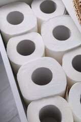 Many toilet paper rolls in white drawer indoors, above view