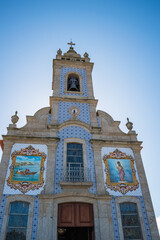 Perspective of the symmetrical facade of the parish church of Mar with a bell tower, portuguese tiles and stained glass windows, São Bartolomeu - Esposende PORTUGAL