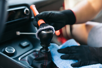 Detailing the car interior with a brush and cloth