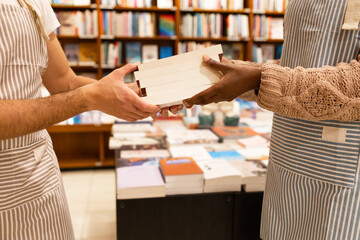 Handover of books at bookstore checkout