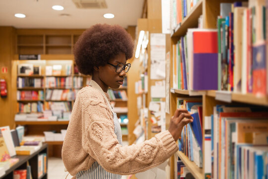 Young African American woman Browsing Books in a Library