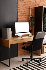 Blank computer monitor with folders on table in modern office