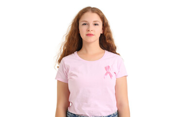 Fototapeta premium Young redhead woman with awareness pink ribbon on white background. Breast cancer concept