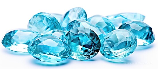 A group of rare blue diamonds with an aquamarine texture are clustered together on a plain white background. The diamonds are vibrant, sparkling, and distinct against the clean backdrop.