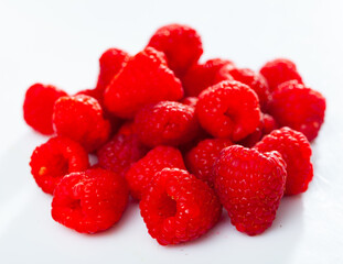 Juicy fresh sweet raspberries close up on isolated white background