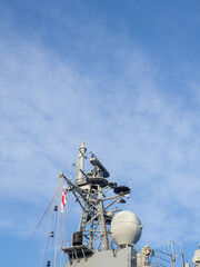 Radar system of a warship. Militarism. Ship electronics. tower against the sky.