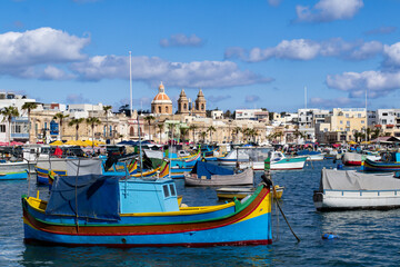 Fototapeta na wymiar A boat and the city, Marsaxlokk Malta 
