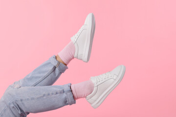 Woman wearing stylish white sneakers on pink background, closeup. Space for text