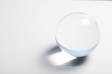 Transparent glass ball on white background. Space for text