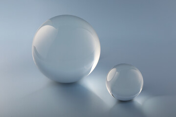 Transparent glass balls on light grey background