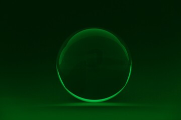 Transparent glass ball on dark green background