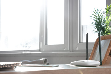 Modern wi-fi router with frame on shelf in room, closeup