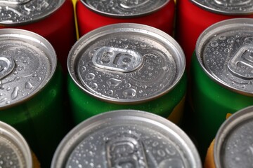 Energy drinks in wet cans, closeup. Functional beverage