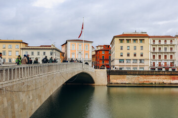 Pisa, Italy - 30 December 2023: Embankments of the Arno River in the center of Pisa, in Tuscany, central Italy - obrazy, fototapety, plakaty