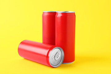 Energy drinks in red cans on yellow background