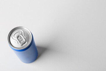 Energy drink in blue can on light grey background, above view. Space for text