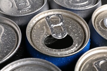 Energy drinks in wet cans as background, closeup. Functional beverage