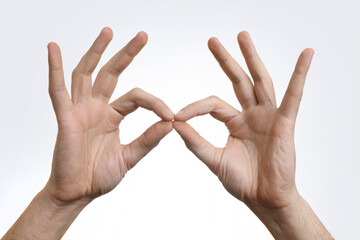 Man holding something in hands on white background, closeup