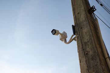 Fototapeta premium CCTV surveillance security camera video equipment on pole outdoor building safety system area control and copy space
