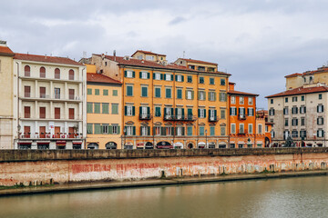 Fototapeta na wymiar Embankments of the Arno River in the center of Pisa, in Tuscany, central Italy