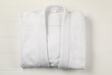 White kimono on wooden background, top view