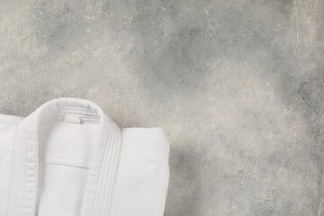 White kimono on gray background, top view. Space for text