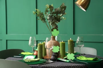 Rolgordijnen Festive table serving with burning candles and clovers. St. Patrick's Day celebration © Pixel-Shot