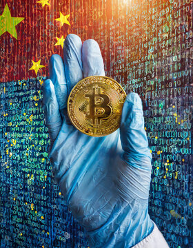  A hand wearing a blue disposable glove holds a bitcoin cryptocurrency with patterned China flag on the background of the electronic board. Bitcoin background for financial and web markets.