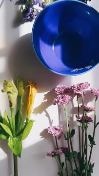 blue bowl, flowers, centerpiece, floral arrangement, summer flowers, spring flowers, colorful flowers, floating flowers, water, reflection, table decoration, interior design, living room, dining room,