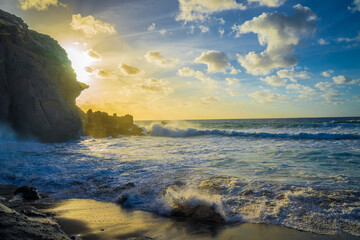 West coast of Fuerteventura, Canary Islands. Ocean waves crashing against the rocky shore at sunset...