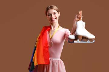 Female figure skater with first place medal and LGBT flag on brown background