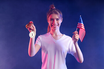 Female tennis player with first place medal and USA flag on dark background