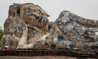 lying buddha in Wat Lokkayasutharam (Phra Buddha Sai Yat), a Buddhist temple of archaeological park, Ayutthaya, Thailand