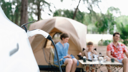 Outdoor adventure and family vacation camping in nature travel by eco friendly car for sustainable...
