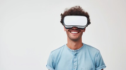 A young male wearing VR head set over plain background.