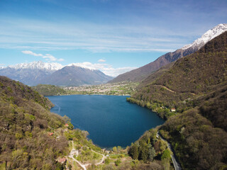 Fototapeta premium Swiss mountain lake in summer surrounded by lush green meadows and alpine peaks.