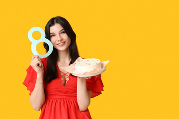 Beautiful young woman with sweet bento cake and figure 8 made of paper on yellow background....