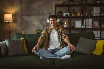 One teen man doing guided meditation yoga self care practice at home