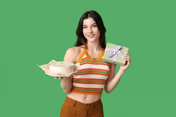 Poster Beautiful young woman with sweet bento cake and gift box on green background. International Women's Day © Pixel-Shot