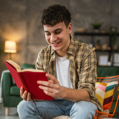 Young man caucasian teenager read book study at home education concept