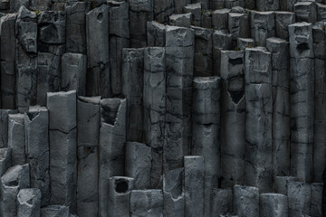 Wall of basalt columns in Iceland creating geometrical patterns