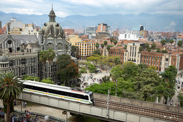 Naklejka premium Medellin, Antioquia. Colombia - December 6, 2023. Panoramic of the city center, which the mass transportation metro crosses