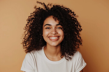 Portrait of a cheerful smiling young brunette with afro hair on pastel background. Generative AI. - obrazy, fototapety, plakaty