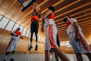Low angle view of diverse basketball players in action at the hoop.